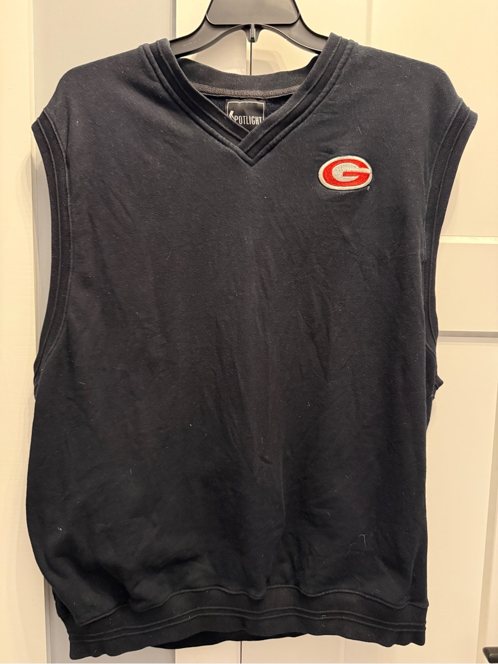 Spotlight Men’s Black V-Neck Sleeveless Sweater with Red Logo